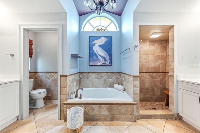 2812 SW 29th Ave, Cape Coral, FL 33914 - bathroom featuring vanity, a garden tub, toilet, tile patterned flooring, and tiled shower