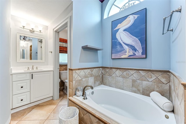 2812 SW 29th Ave, Cape Coral, FL 33914 - full bathroom featuring toilet, a garden tub, vanity, and tile patterned floors