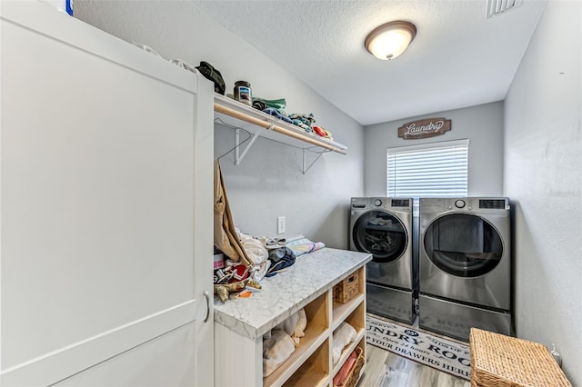 2812 SW 29th Ave, Cape Coral, FL 33914 - laundry area with washing machine and clothes dryer, light wood-style flooring, and a textured ceiling