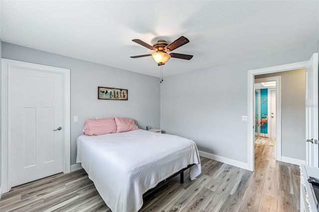 2812 SW 29th Ave, Cape Coral, FL 33914 - bedroom with light wood-style floors, baseboards, and ceiling fan