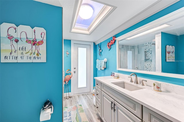 2812 SW 29th Ave, Cape Coral, FL 33914 - full bathroom with vanity, wood finished floors, baseboards, and a shower with shower curtain