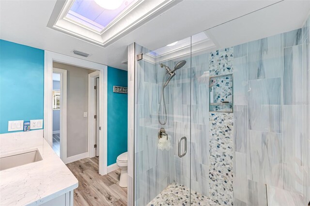 2812 SW 29th Ave, Cape Coral, FL 33914 - full bath featuring a stall shower, vanity, wood finished floors, and toilet