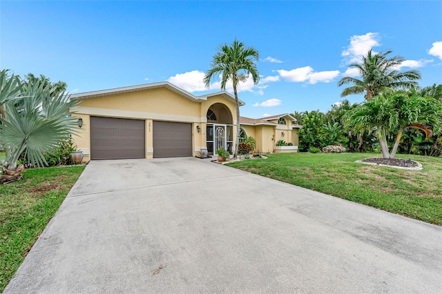 2812 SW 29th Ave, Cape Coral, FL 33914 - view of front of home featuring stucco siding, an attached garage, a front lawn, and concrete driveway