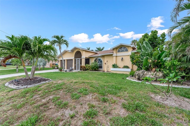 2812 SW 29th Ave, Cape Coral, FL 33914 - view of front of property with stucco siding, an attached garage, a front yard, and driveway
