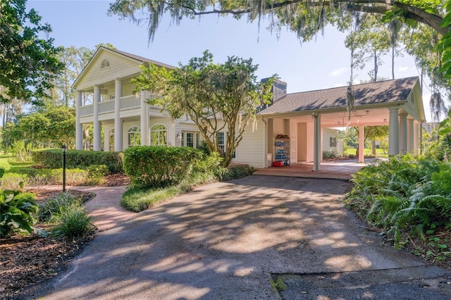 15612 Howell Park Ln, Tampa, FL 33625 - view of front of property featuring a porch, a chimney, driveway, and an attached carport
