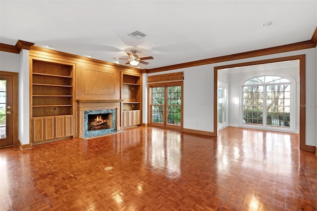 15612 Howell Park Ln, Tampa, FL 33625 - unfurnished living room featuring crown molding, baseboards, ceiling fan, a fireplace, and built in features