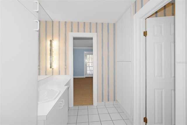 15612 Howell Park Ln, Tampa, FL 33625 - hallway with light tile patterned floors, wallpapered walls, a sink, light carpet, and baseboards