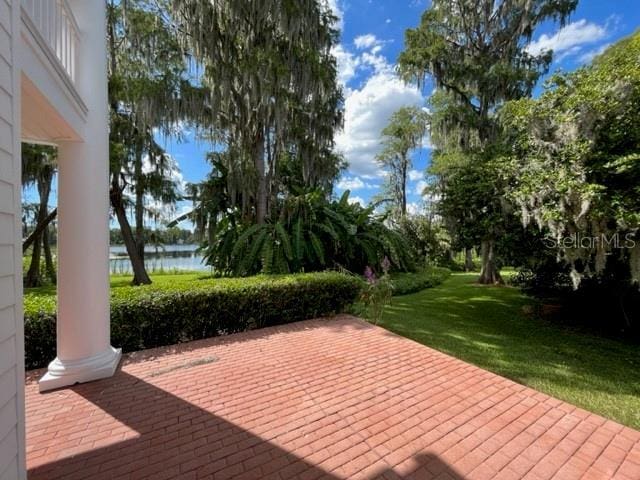 15612 Howell Park Ln, Tampa, FL 33625 - wooden deck featuring a water view, a patio, and a lawn