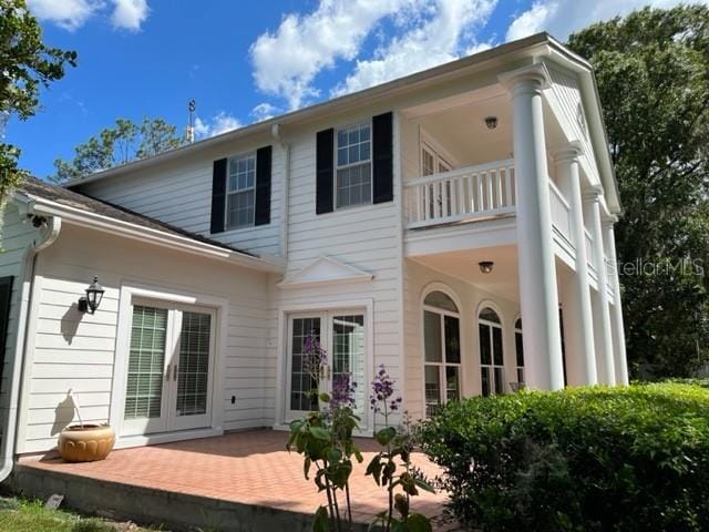 15612 Howell Park Ln, Tampa, FL 33625 - back of house with a balcony, french doors, and a patio area