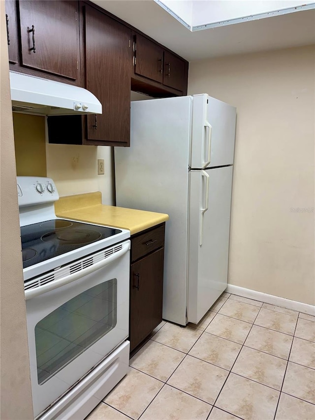 6324 Newtown Cir Unit 24B2, Tampa, FL 33615 - kitchen featuring white appliances, under cabinet range hood, dark brown cabinetry, light tile patterned floors, and light countertops