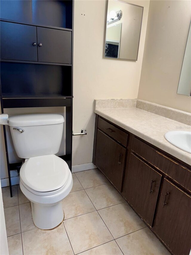 6324 Newtown Cir Unit 24B2, Tampa, FL 33615 - half bath featuring toilet, vanity, tile patterned floors, and baseboards