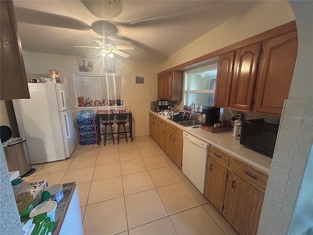 18133 US Highway 41, Spring Hill, FL 34610 - kitchen featuring a sink, white appliances, light tile patterned floors, a ceiling fan, and light countertops