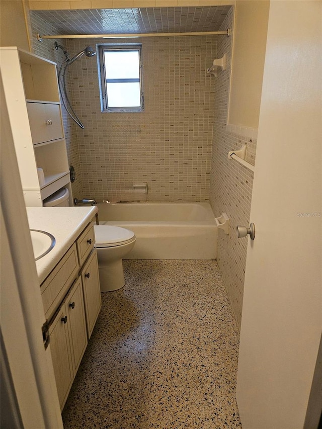 bathroom featuring vanity, shower / washtub combination, and speckled floor
