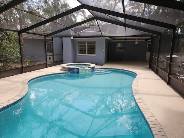 view of pool featuring a lanai, a patio, ceiling fan, and a pool with connected hot tub