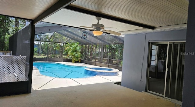 view of pool with a pool with connected hot tub, a ceiling fan, a patio area, and a lanai