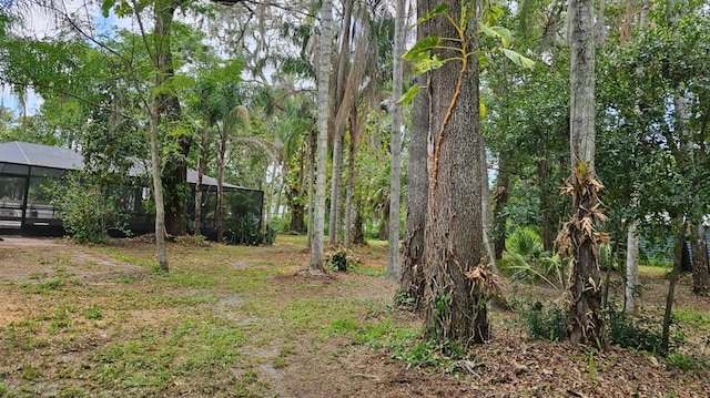 view of yard featuring glass enclosure