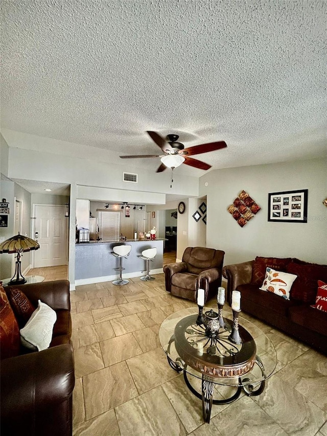 11521 Paperwood Pl, Riverview, FL 33579 - living room featuring a ceiling fan and a textured ceiling