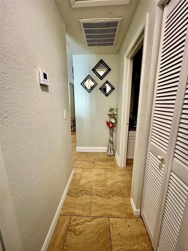 11521 Paperwood Pl, Riverview, FL 33579 - hall featuring a textured wall, baseboards, and a textured ceiling