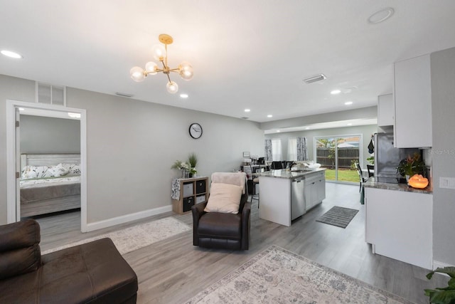 8339 75th Ave, Seminole, FL 33777 - living room featuring light wood finished floors, recessed lighting, a chandelier, and baseboards