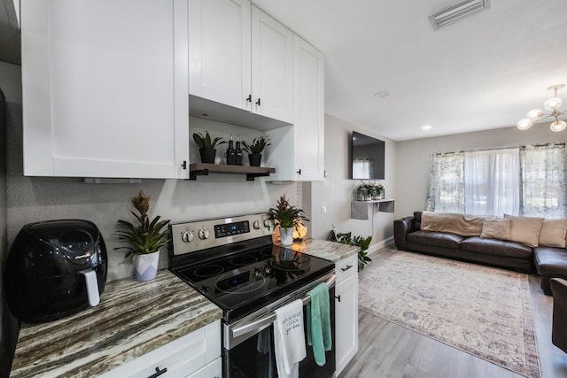 8339 75th Ave, Seminole, FL 33777 - kitchen featuring electric stove, white cabinets, wood finished floors, light stone counters, and open shelves