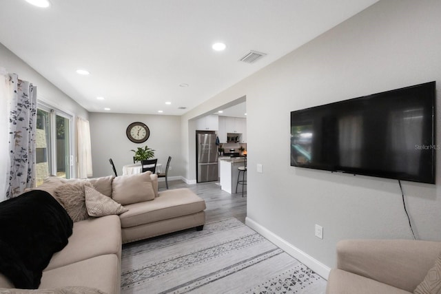 8339 75th Ave, Seminole, FL 33777 - living room with baseboards, light wood-type flooring, and recessed lighting