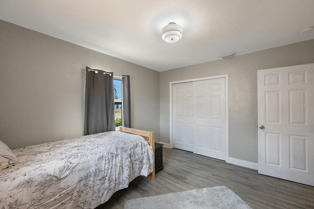 8339 75th Ave, Seminole, FL 33777 - bedroom with wood finished floors, a closet, and baseboards