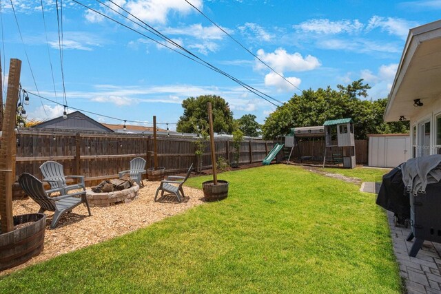 8339 75th Ave, Seminole, FL 33777 - view of yard featuring a fire pit and a playground