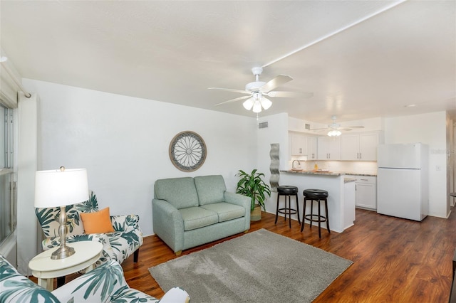 4154 56th St N Unit 720, Kenneth City, FL 33709 - living area with a ceiling fan and dark wood-style flooring