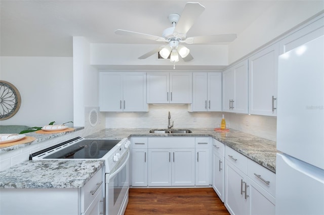 4154 56th St N Unit 720, Kenneth City, FL 33709 - kitchen with white appliances, a sink, white cabinetry, tasteful backsplash, and light stone countertops