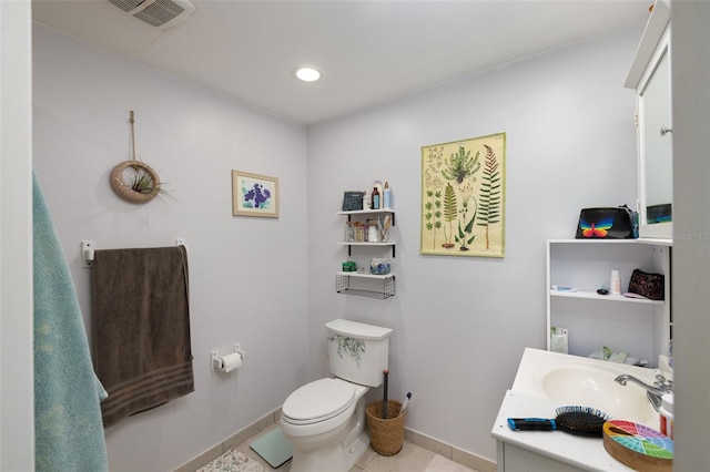 824 31st Ave N, Saint Petersburg, FL 33704 - bathroom with toilet, baseboards, vanity, tile patterned floors, and recessed lighting