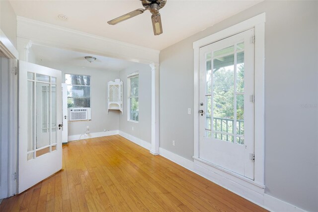 824 31st Ave N, Saint Petersburg, FL 33704 - foyer entrance featuring baseboards, ceiling fan, light wood-style flooring, cooling unit, and ornate columns