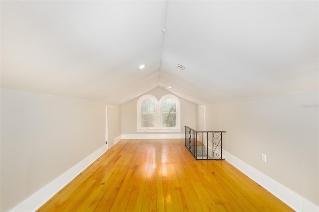 824 31st Ave N, Saint Petersburg, FL 33704 - additional living space with vaulted ceiling, baseboards, and light wood-style flooring