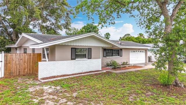 1737 Prince Philip St, Clearwater, FL 33755 - ranch-style house with a garage, roof with shingles, stucco siding, and driveway