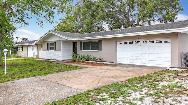 1737 Prince Philip St, Clearwater, FL 33755 - single story home featuring an attached garage, concrete driveway, brick siding, a front lawn, and roof with shingles