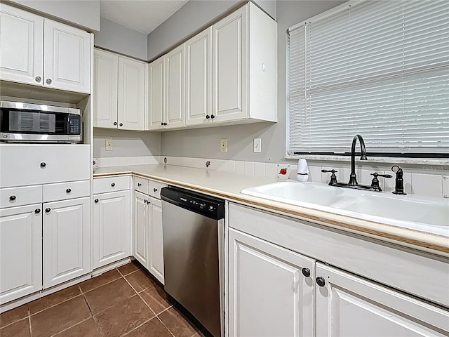 1737 Prince Philip St, Clearwater, FL 33755 - kitchen with appliances with stainless steel finishes, a sink, and white cabinetry