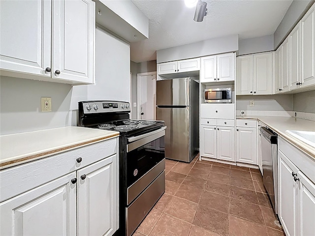 1737 Prince Philip St, Clearwater, FL 33755 - kitchen with stainless steel appliances, white cabinetry, and light countertops
