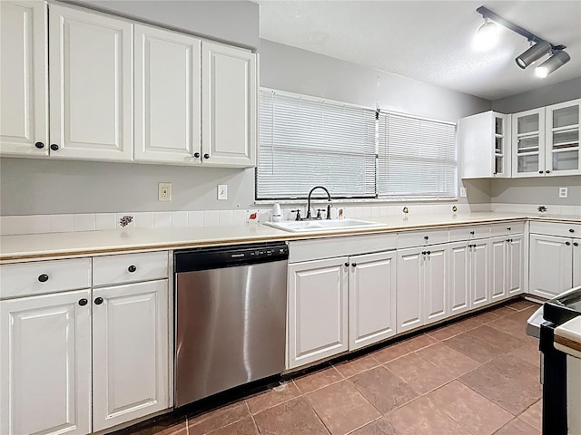 1737 Prince Philip St, Clearwater, FL 33755 - kitchen with stainless steel dishwasher, a sink, and white cabinetry