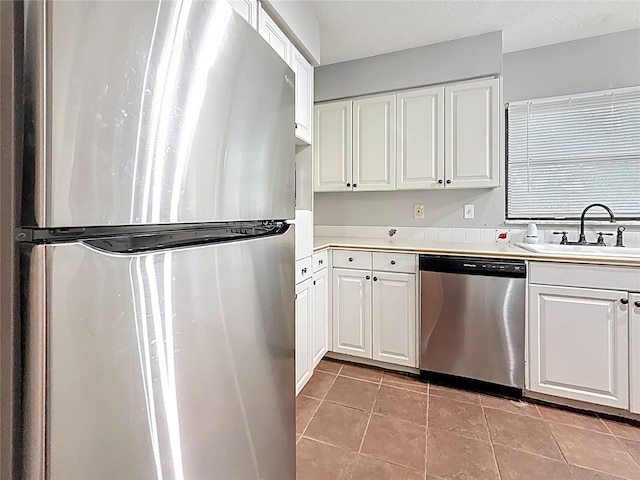 1737 Prince Philip St, Clearwater, FL 33755 - kitchen featuring appliances with stainless steel finishes, a sink, white cabinetry, and light countertops