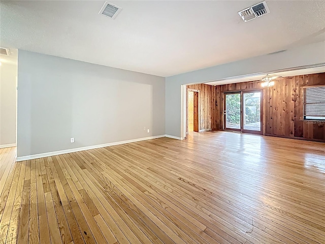 1737 Prince Philip St, Clearwater, FL 33755 - empty room with light wood-type flooring, baseboards, and wood walls