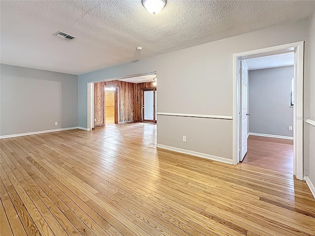 1737 Prince Philip St, Clearwater, FL 33755 - empty room with light wood-type flooring, baseboards, and a textured ceiling