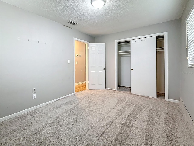 1737 Prince Philip St, Clearwater, FL 33755 - unfurnished bedroom with a closet, carpet floors, a textured ceiling, and baseboards