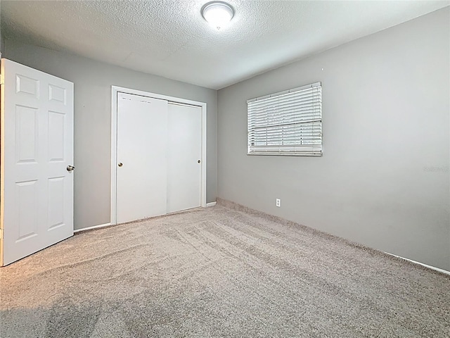 1737 Prince Philip St, Clearwater, FL 33755 - unfurnished bedroom with carpet, a closet, and a textured ceiling