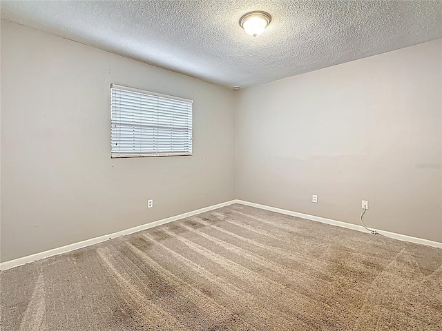 1737 Prince Philip St, Clearwater, FL 33755 - empty room featuring carpet floors, a textured ceiling, and baseboards