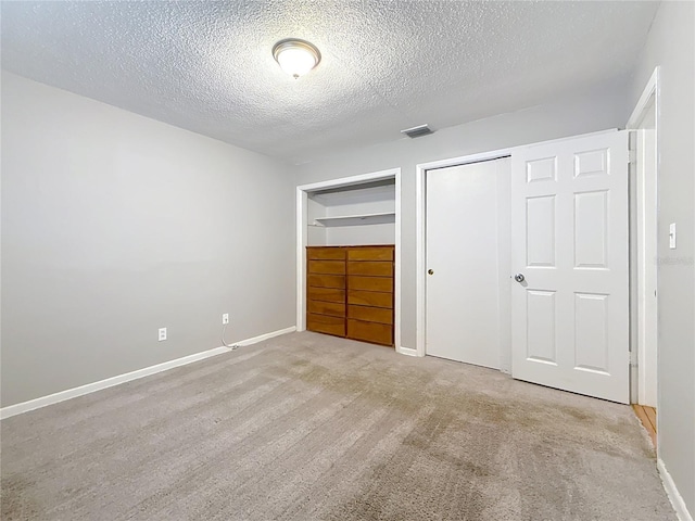 1737 Prince Philip St, Clearwater, FL 33755 - unfurnished bedroom with a textured ceiling, carpet, baseboards, and two closets