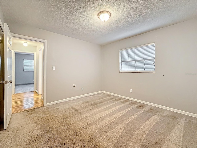 1737 Prince Philip St, Clearwater, FL 33755 - unfurnished room featuring light colored carpet, a textured ceiling, and baseboards