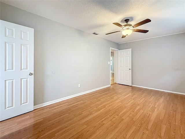 1737 Prince Philip St, Clearwater, FL 33755 - unfurnished room with light wood-type flooring, a ceiling fan, baseboards, and a textured ceiling