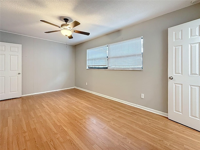 1737 Prince Philip St, Clearwater, FL 33755 - unfurnished room with light wood-type flooring, a ceiling fan, baseboards, and a textured ceiling