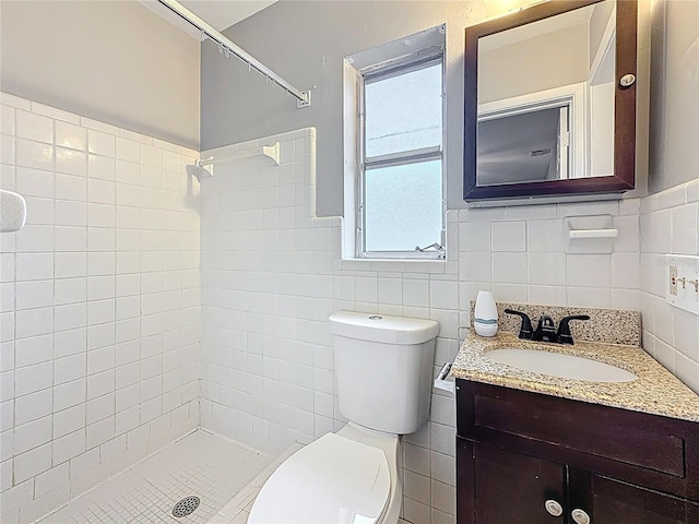 1737 Prince Philip St, Clearwater, FL 33755 - full bathroom with toilet, a tile shower, vanity, tile walls, and a wainscoted wall