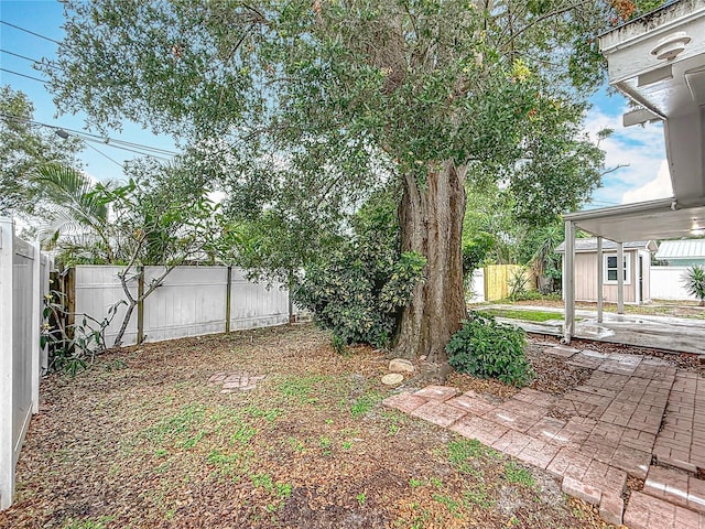 1737 Prince Philip St, Clearwater, FL 33755 - fenced backyard featuring a patio and an outdoor structure