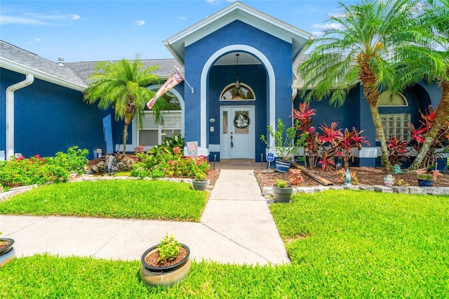 28390 Openfield Loop, Wesley Chapel, FL 33543 - entrance to property featuring stucco siding and a yard